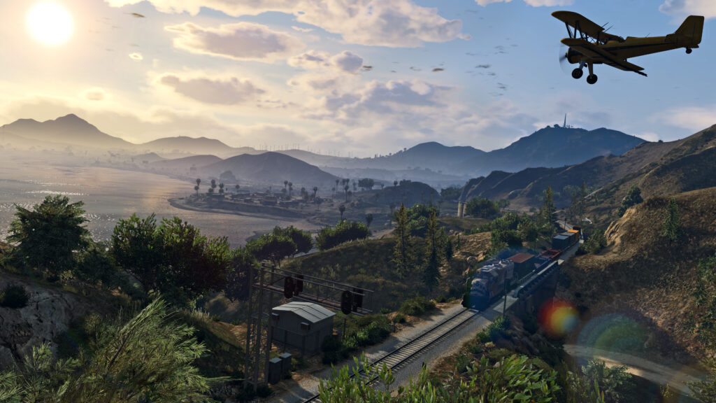 Panorámica de San Andreas y un avión sobre el ferrocarril en una captura oficial de Grand Theft Auto V para PC